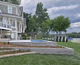 Completed custom in-ground pool and stone terrace at a Long Lake waterfront home