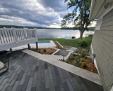 Lakeside walkway and landscaped outdoor living space at a Long Lake waterfront property