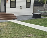 Completed entry stoop and compacted gravel patio at a Minneapolis home with new concrete walkway