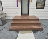 Newly constructed composite entry stoop with concrete walkway at a Minneapolis residence