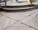 Weathered composite deck with curved steps and outdoor seating area