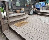 Existing composite deck with curved stairs leading to backyard