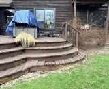 Curved deck steps and weathered decking before deck renovation