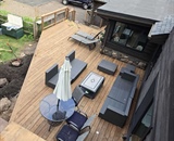 Completed multi-level backyard deck with outdoor dining and seating areas