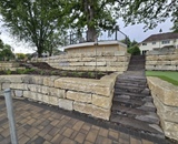 Hardscape patio with stone retaining walls and steps in Champlin, MN
